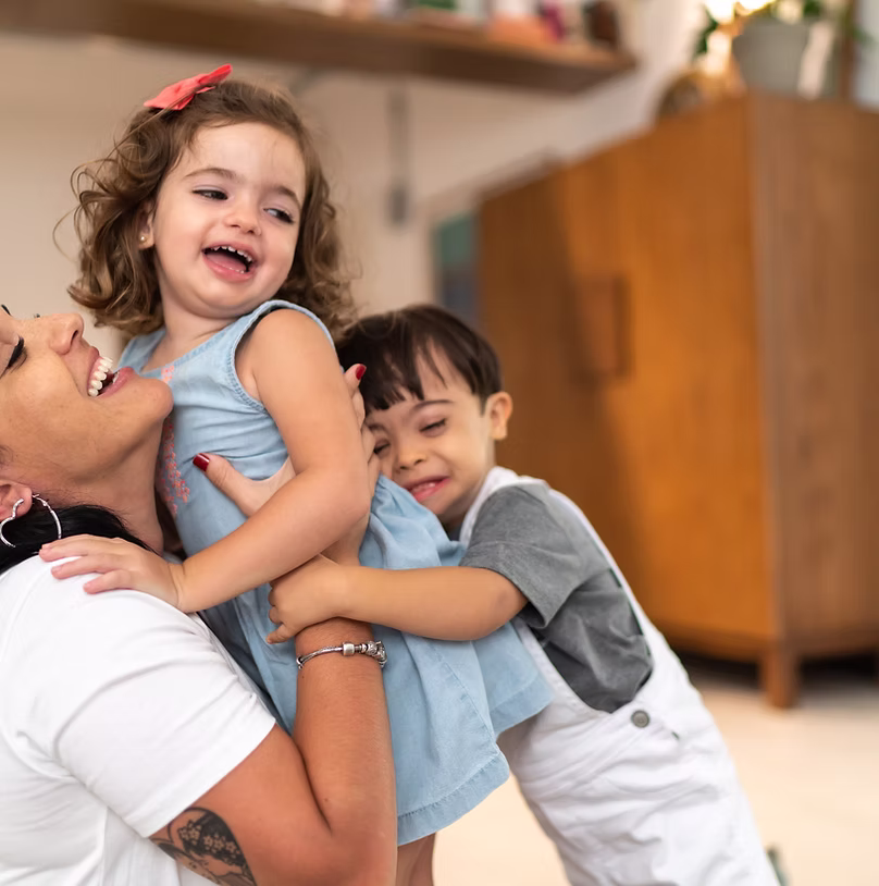 Family members embracing indoors.